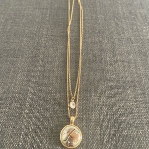 Gold necklace with a K on it